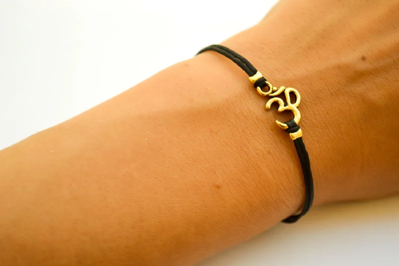 Black cord bracelet with gold tone Om charm, adjustable bracelet for her