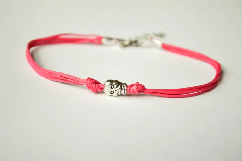 Pink cord bracelet with a silver skull bead charm, gift for her