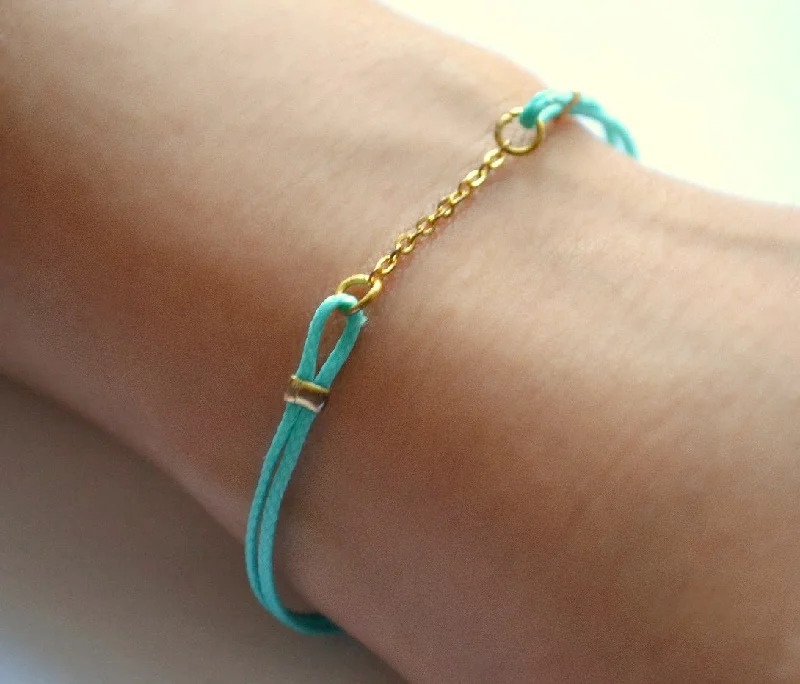 Turquoise cord bracelet with a gold chain