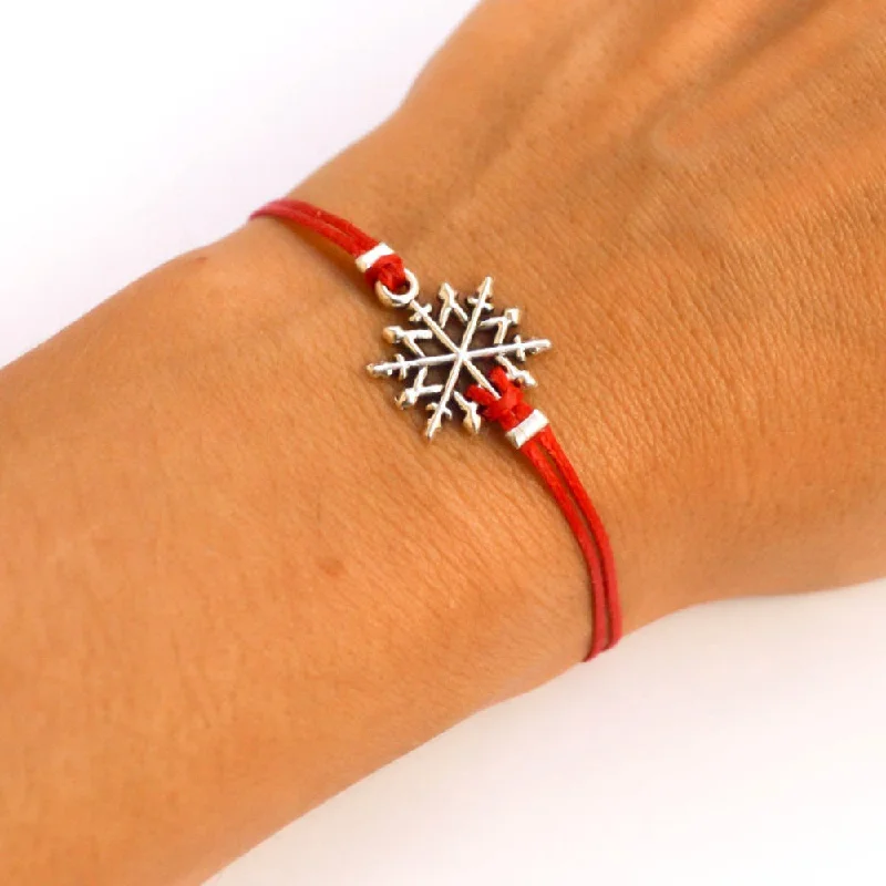 Women bracelet with silver snow flake charm, red cord