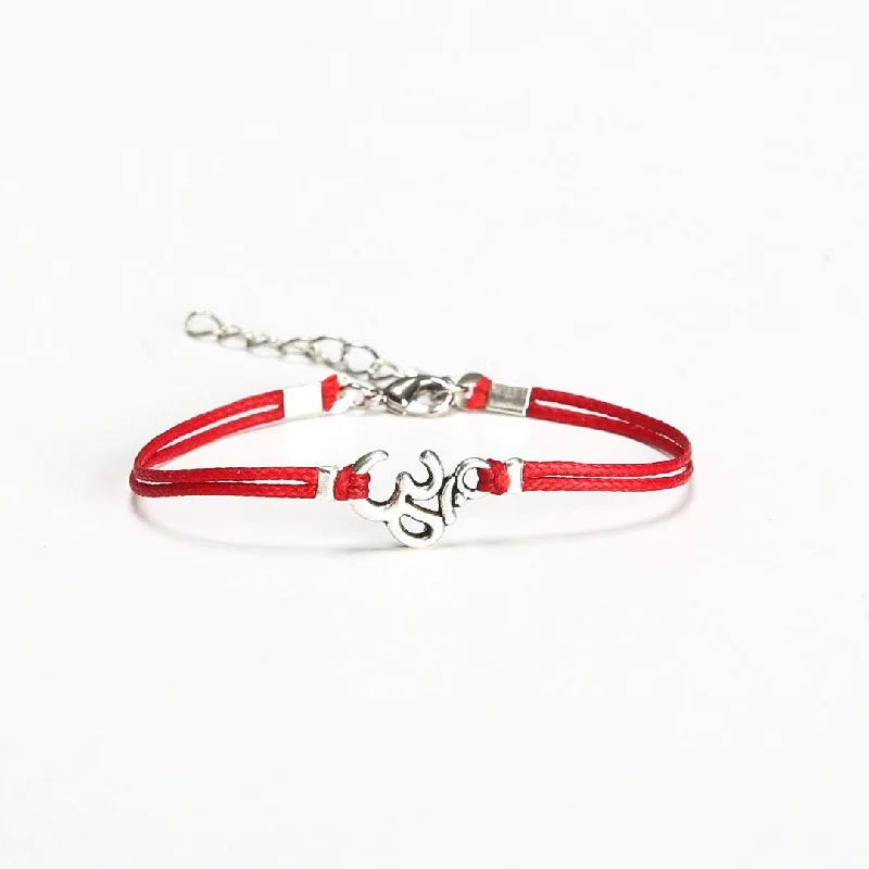 Women bracelet with a silver tone Om charm, red cord, yoga jewelry